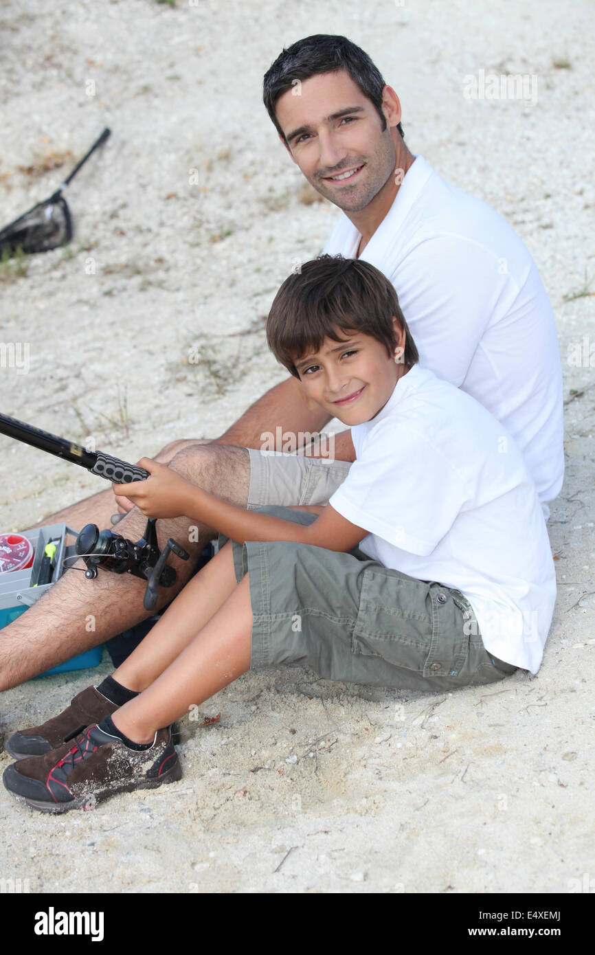 father and son at fishing party Stock Photo