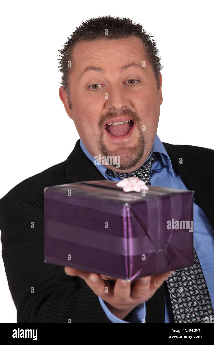Businessman openmouthed at a gift Stock Photo
