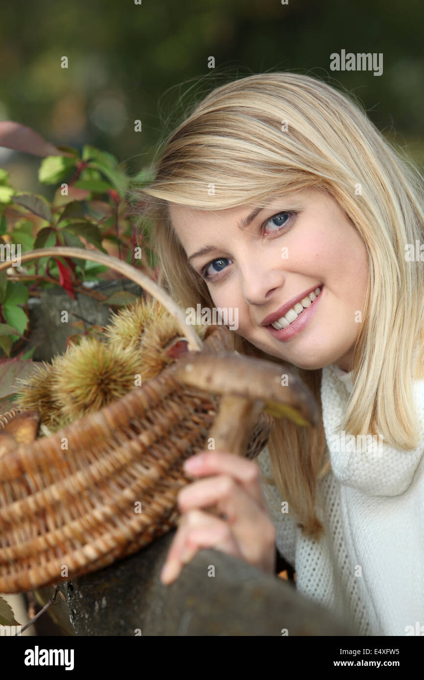 Woman gathering chestnuts Stock Photo