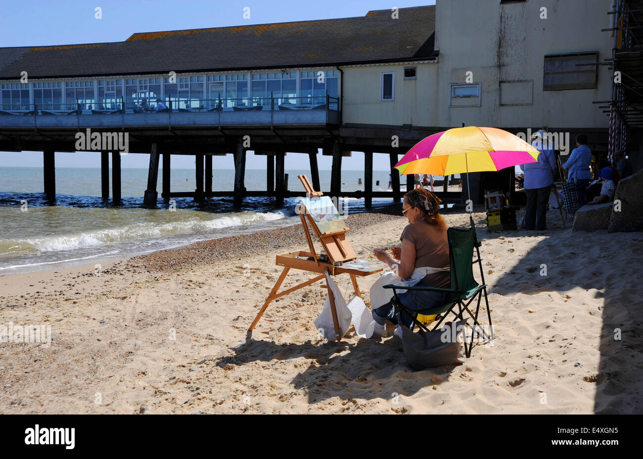 Southwold, Suffolk, UK. 17th July, 2014.  An artist enjoys the hot weather and lovely lighting on Southwold beach as temperatures reached the high 20s centigrade throughout Britain today  Credit:  Simon Dack/Alamy Live News Stock Photo