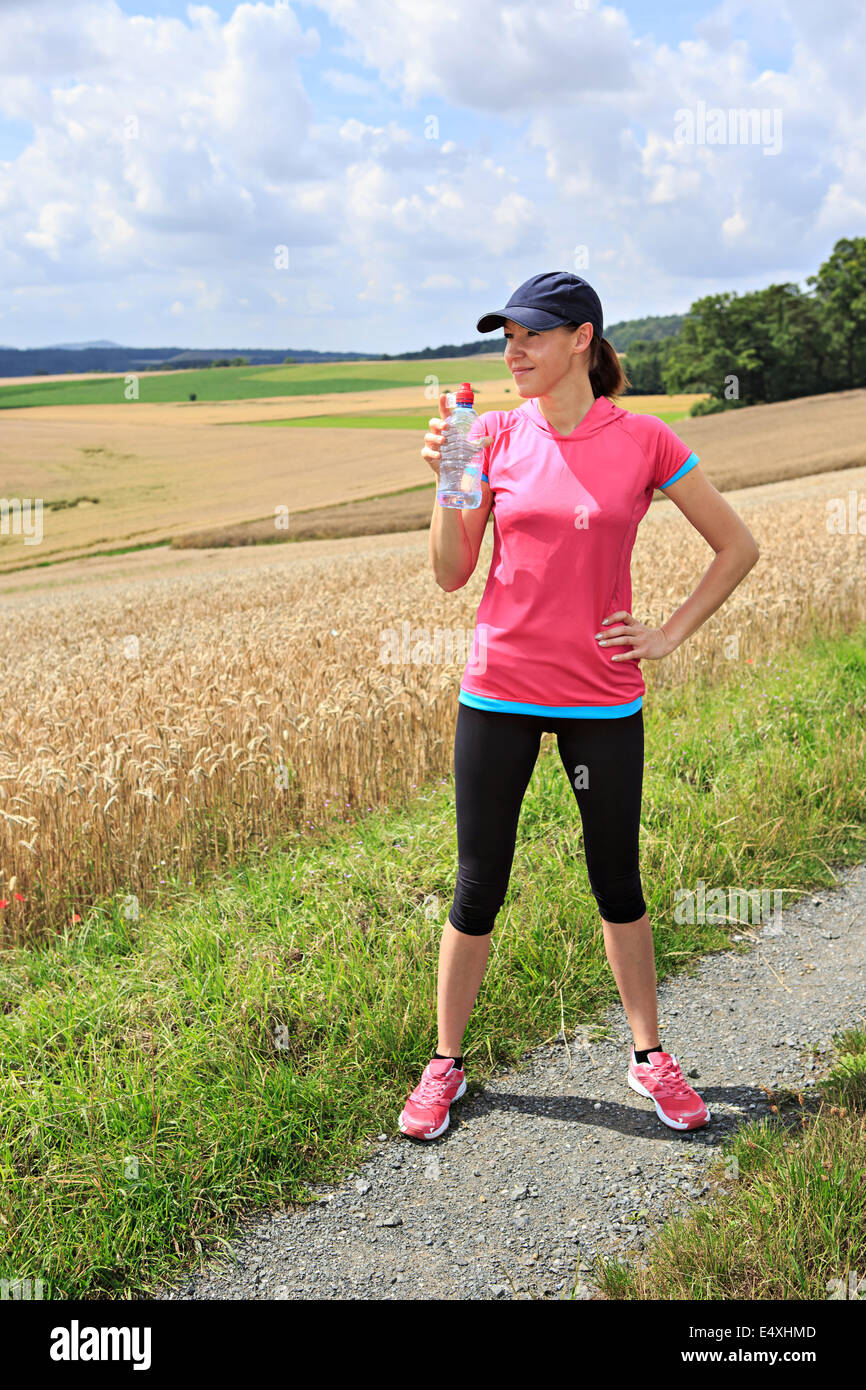 a woman running through the rural landscape Stock Photo