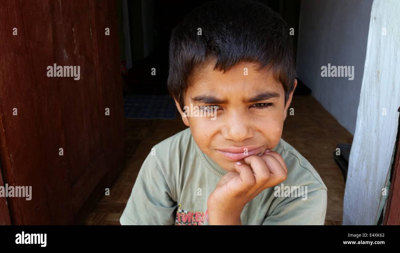 Golqm Dervent, Bulgaria. 17th July, 2014. Bulgarian chidren attends in front of his homr in the village Golqm Dervent as near by Bulgarian Borger police officers attend near newly build 30 kms long border fence at Bulgarian-Turkey border, as they present it to the press Thursday, July, 17, 2014. The wave of refugees flocking to Bulgaria has been growing again over the past few weeks. Bulgaria builded the fence on its border with Turkey to end illegal border crossings into the country. Credit: ZUMA Press, Inc./Alamy Live News Stock Photo