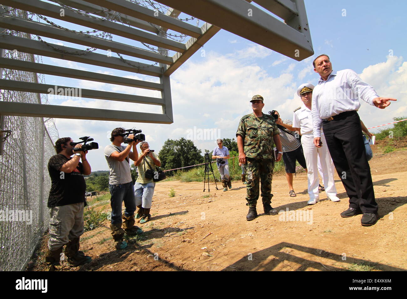 Golqm Dervent, Bulgaria. 17th July, 2014. Bulgarian Defense Minister Angel Naidenov speaks to the Press as Bulgarian Borger police officers attend near newly build 30 kms long border fence at Bulgarian-Turkey border, as they present it to the press Thursday, July, 17, 2014. The wave of refugees flocking to Bulgaria has been growing again over the past few weeks. Bulgaria builded the fence on its border with Turkey to end illegal border crossings into the country. Credit:  ZUMA Press, Inc./Alamy Live News Stock Photo