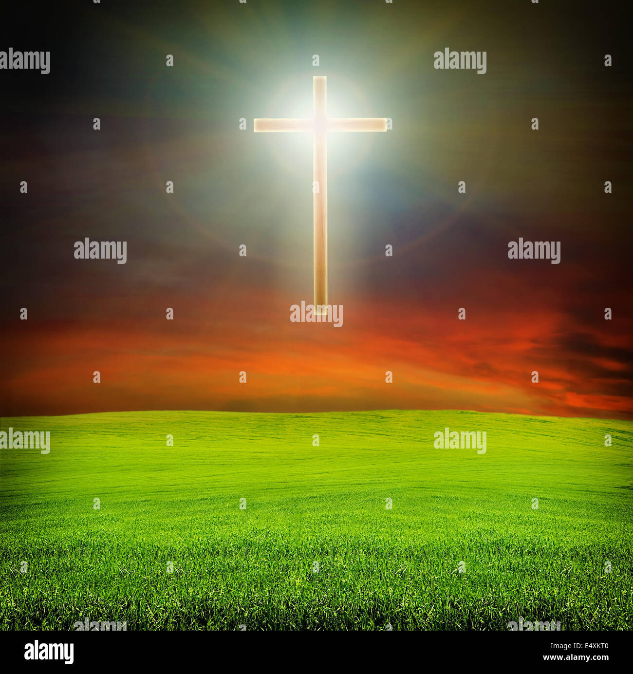 shining cross over dark sky and field Stock Photo