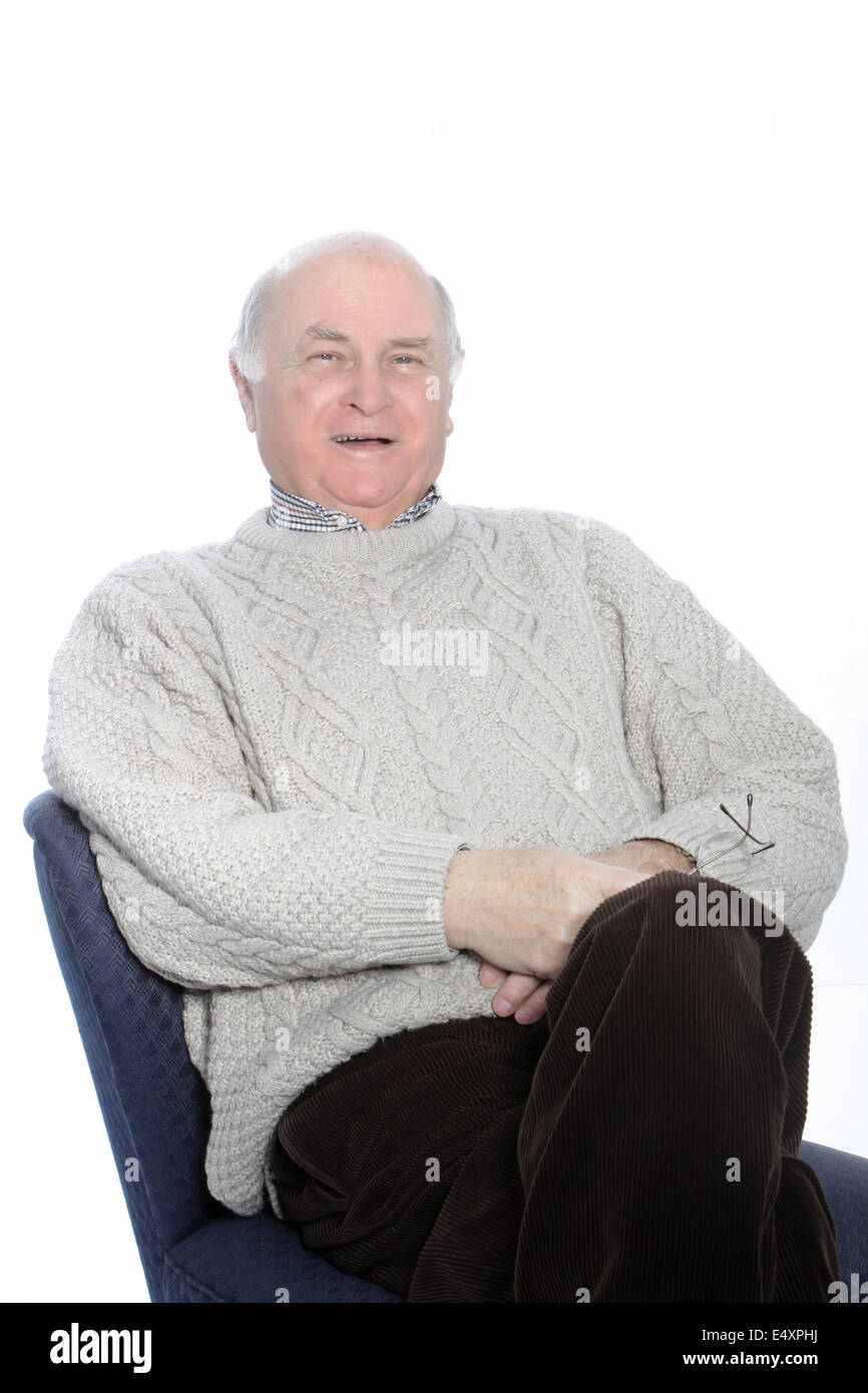 Happy senior man relaxing in a chair Stock Photo