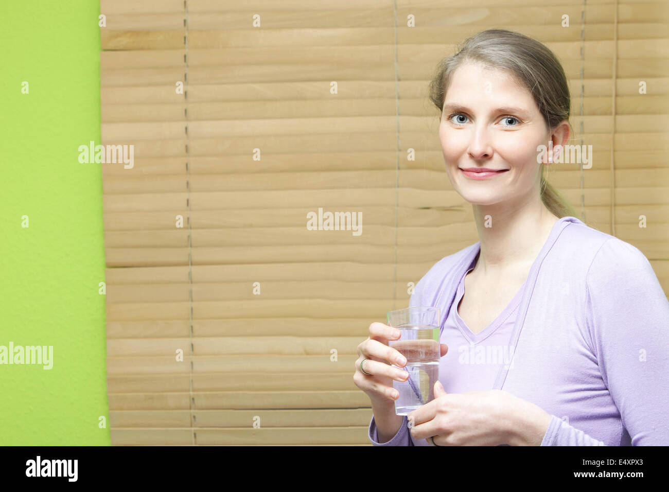 A young attractive woman holding a glass Stock Photo