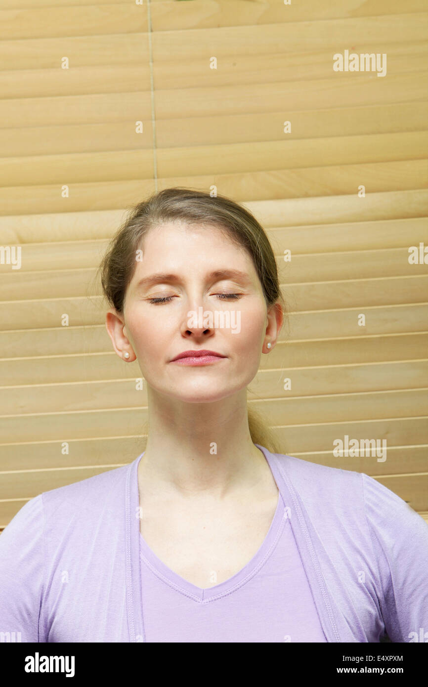 Woman meditating with closed eyes Stock Photo Alamy