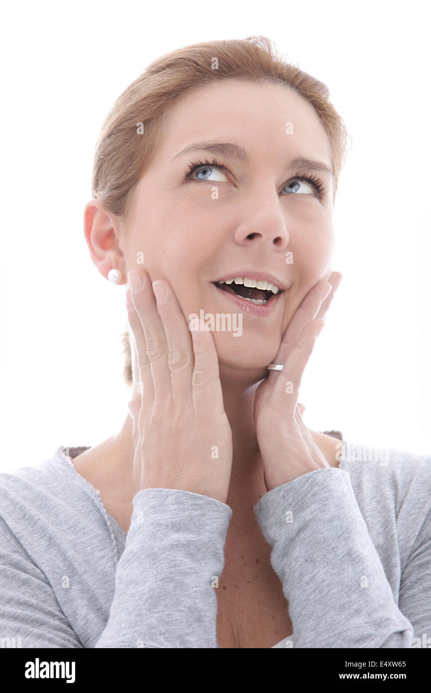 Woman thinking with her hands to her face Stock Photo