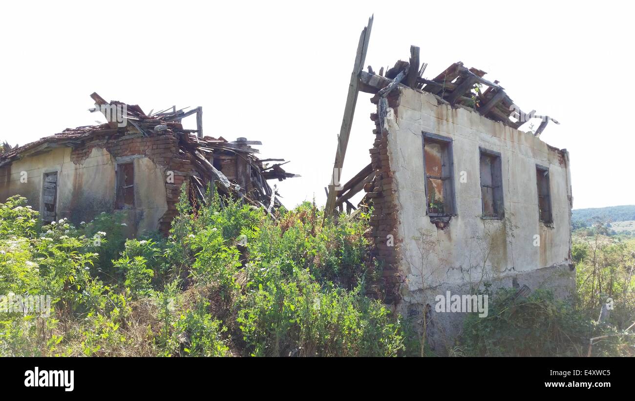 Golqm Dervent, Bulgaria. 17th July, 2014. A broken house in the village Golqm Dervent as near by Bulgarian Borger police officers attend near newly build 30 kms long border fence at Bulgarian-Turkey border, as they present it to the press Thursday, July, 17, 2014. The wave of refugees flocking to Bulgaria has been growing again over the past few weeks. Bulgaria builded the fence on its border with Turkey to end illegal border crossings into the country. Credit: ZUMA Press, Inc./Alamy Live News Stock Photo