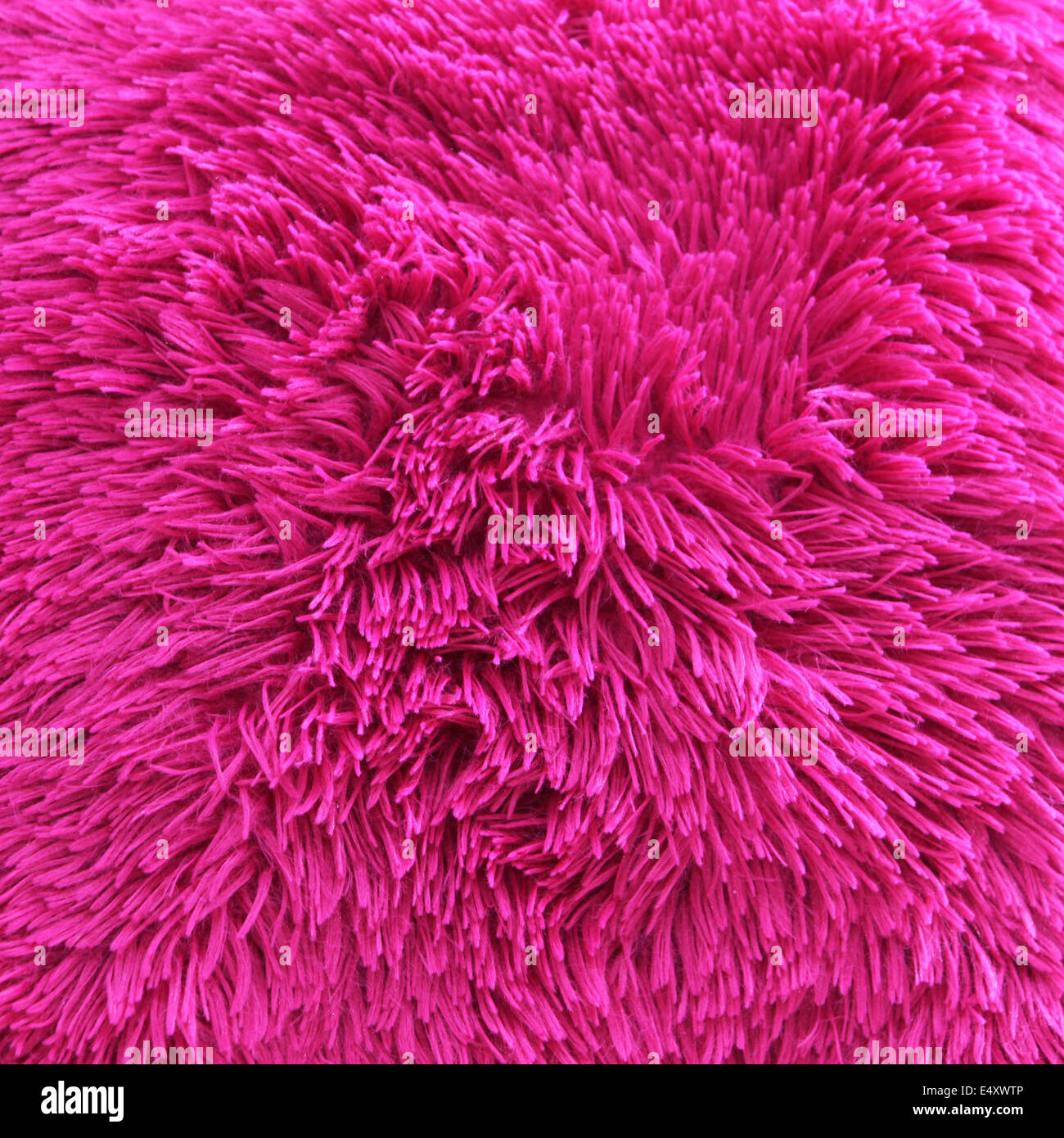 Vivid pink shaggy carpet pile Stock Photo
