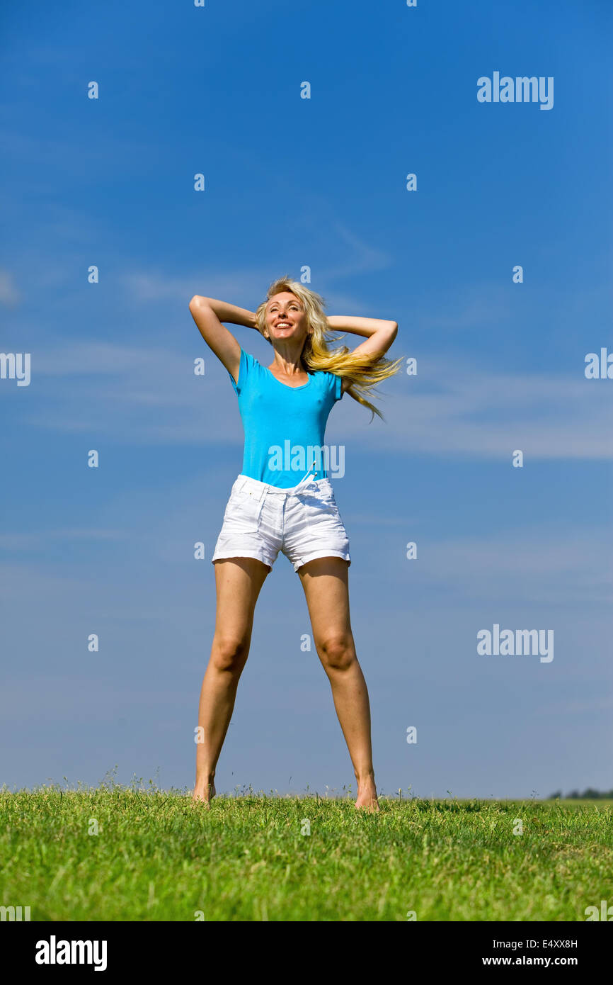 The happy young woman  in the field Stock Photo