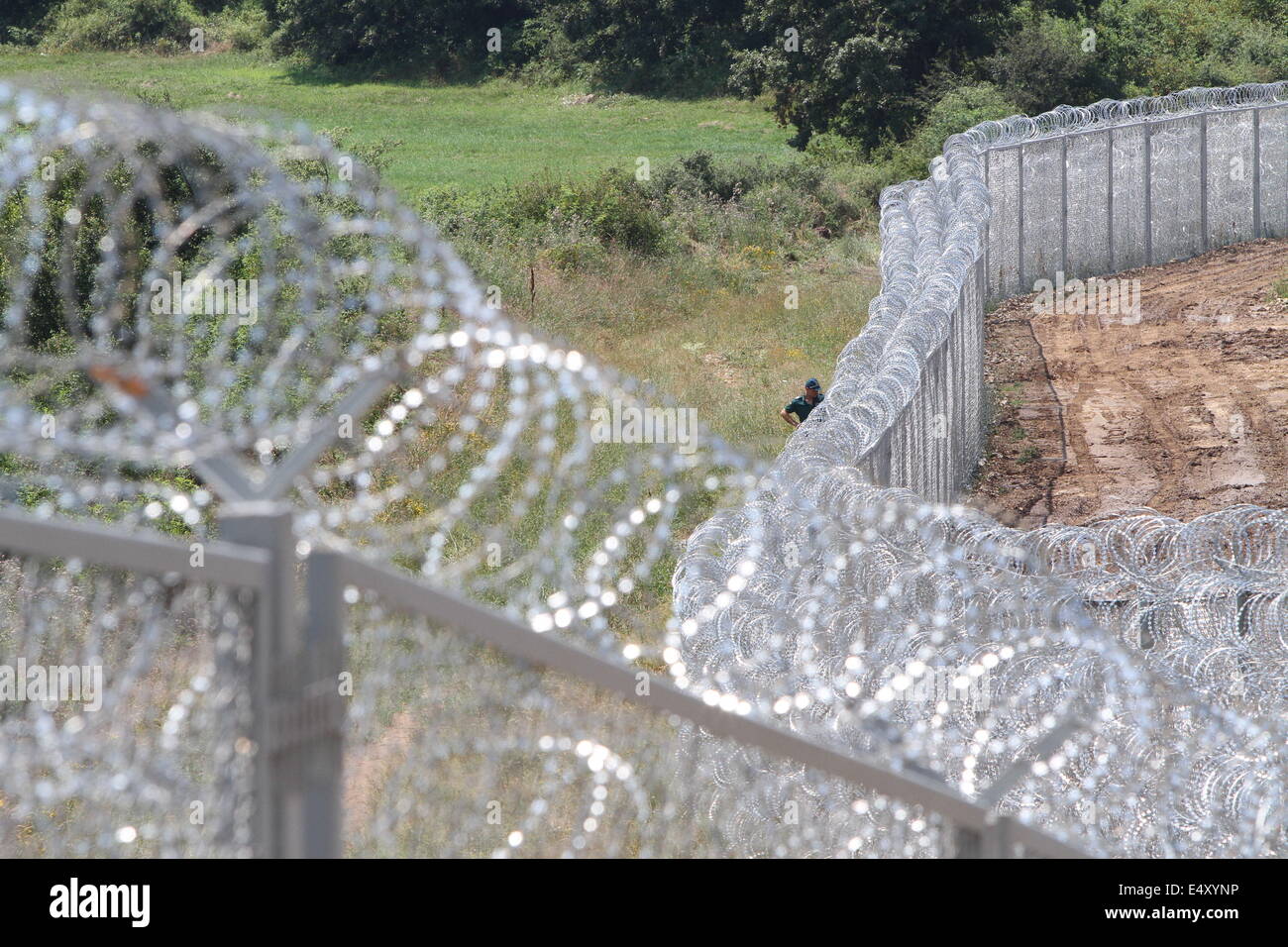 Golqm Dervent, Bulgaria. 17th July, 2014. Bulgarian Borger police officers attend near newly build 30 kms long border fence at Bulgarian-Turkey border, as they present it to the press Thursday, July, 17, 2014. The wave of refugees flocking to Bulgaria has been growing again over the past few weeks. Bulgaria builded the fence on its border with Turkey to end illegal border crossings into the country.The idea of building of a 30 kilometer wire fence has gained traction since late last year due to the government concerns over the Syrian refugee influx. Credit:  ZUMA Press, Inc./Alamy Live News Stock Photo