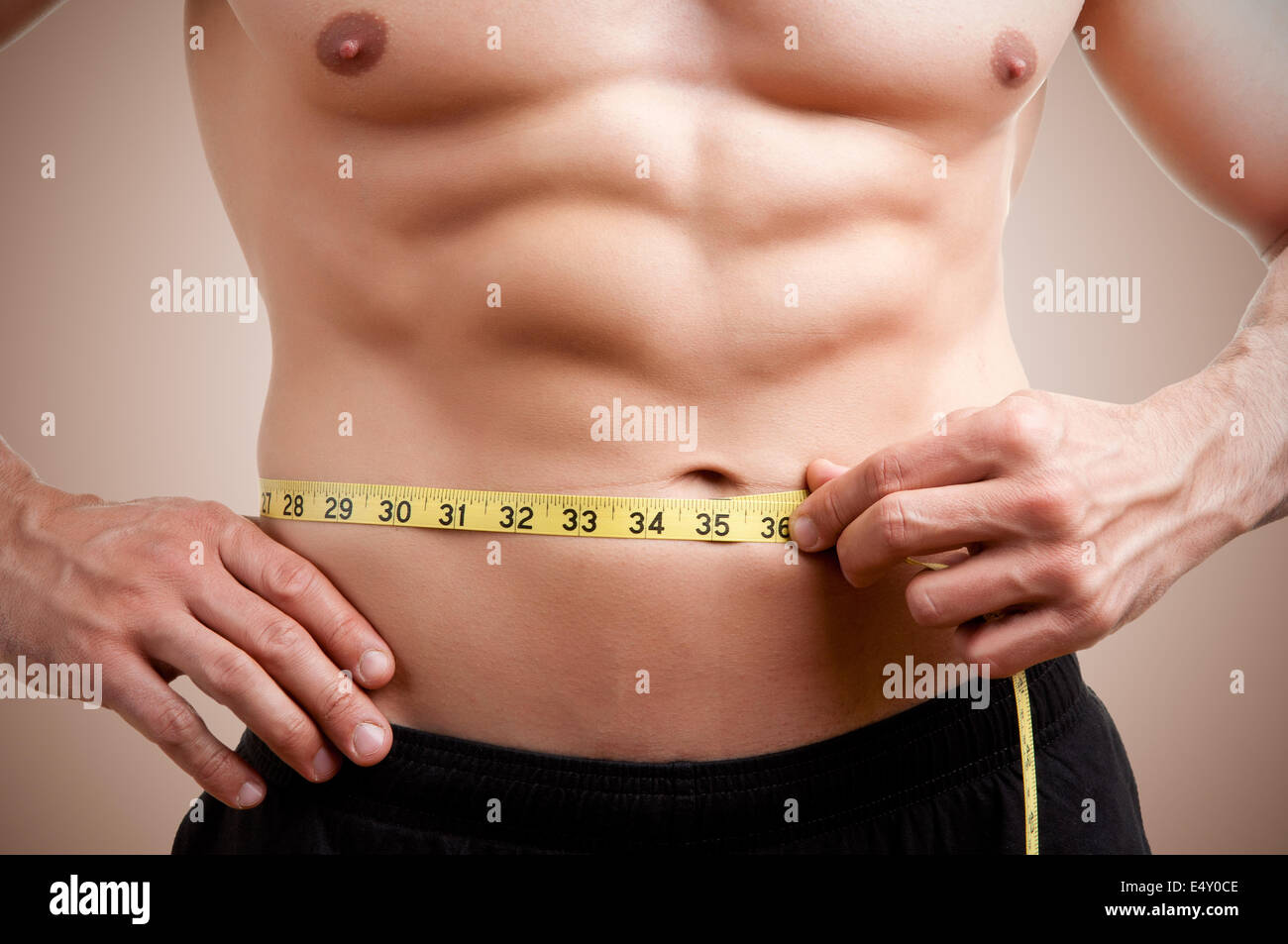Fit Man Measuring His Waist Stock Photo