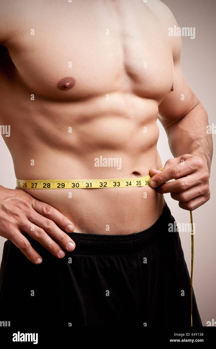 Fit Man Measuring His Waist Stock Photo