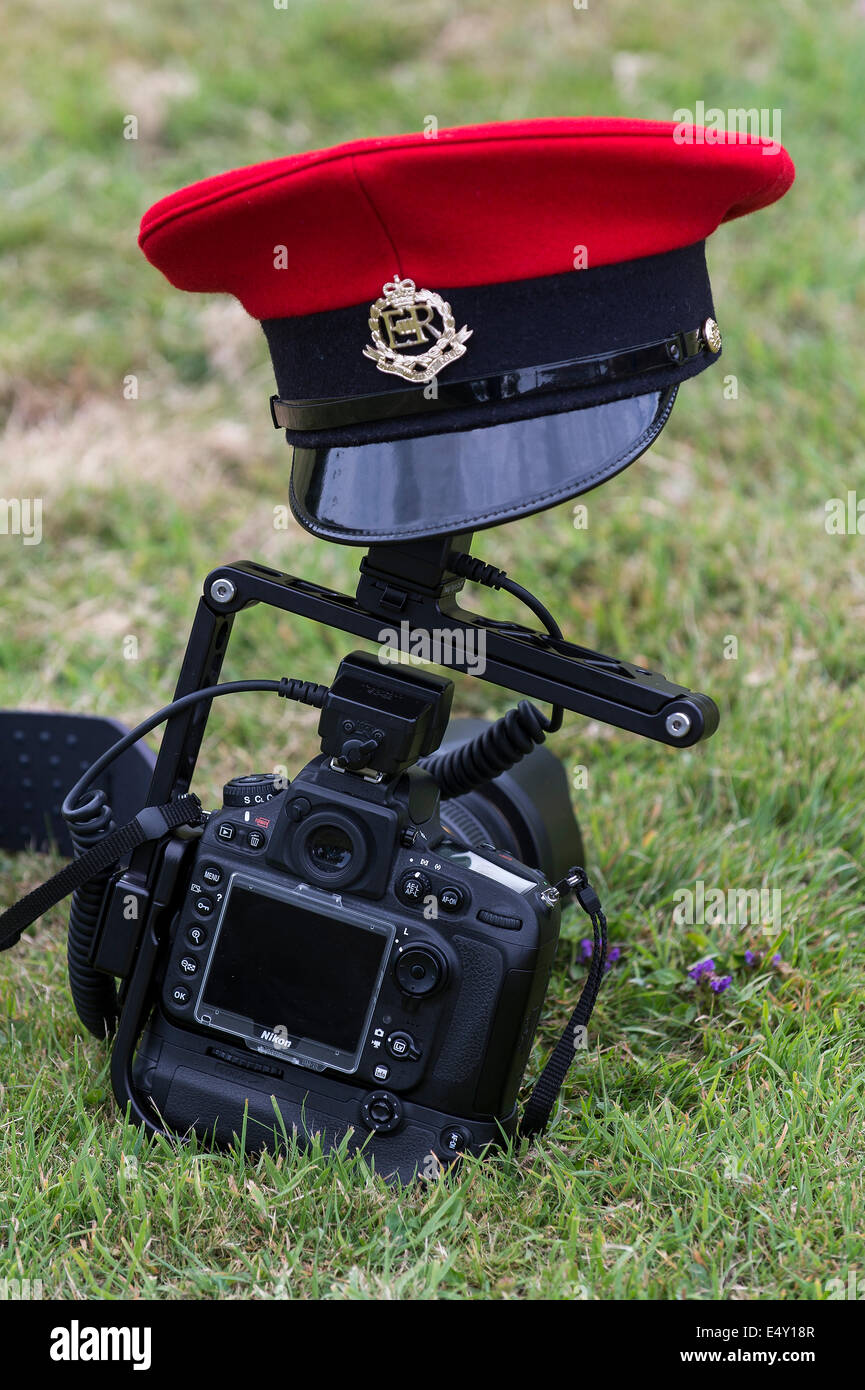 A Royal Military Police peaked cap, from a Military Police dress uniform, resting on a Nikon D800 camera. Stock Photo