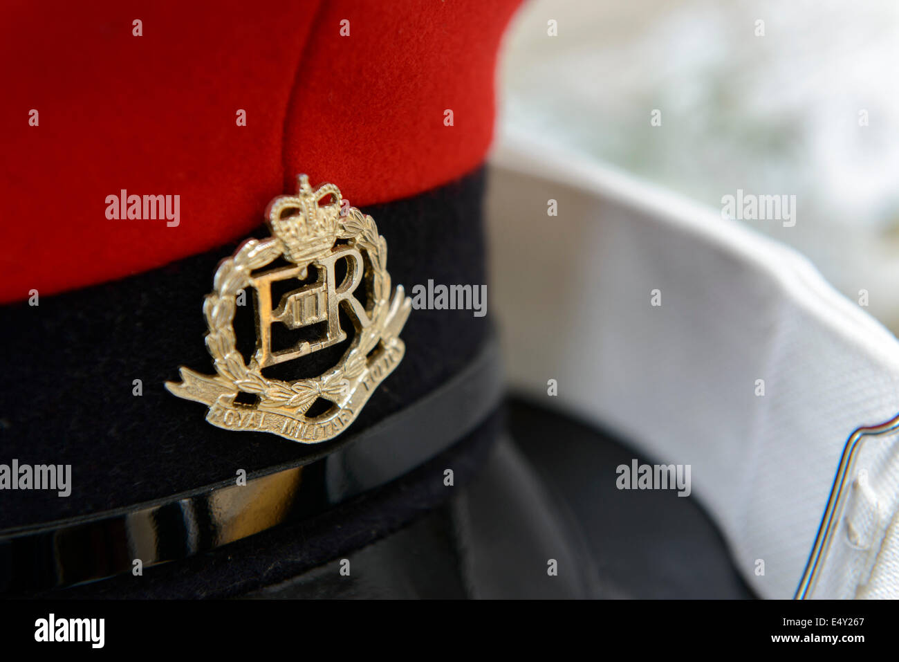 A Royal Military Police peaked cap and white belt from a Military Police dress uniform. Stock Photo