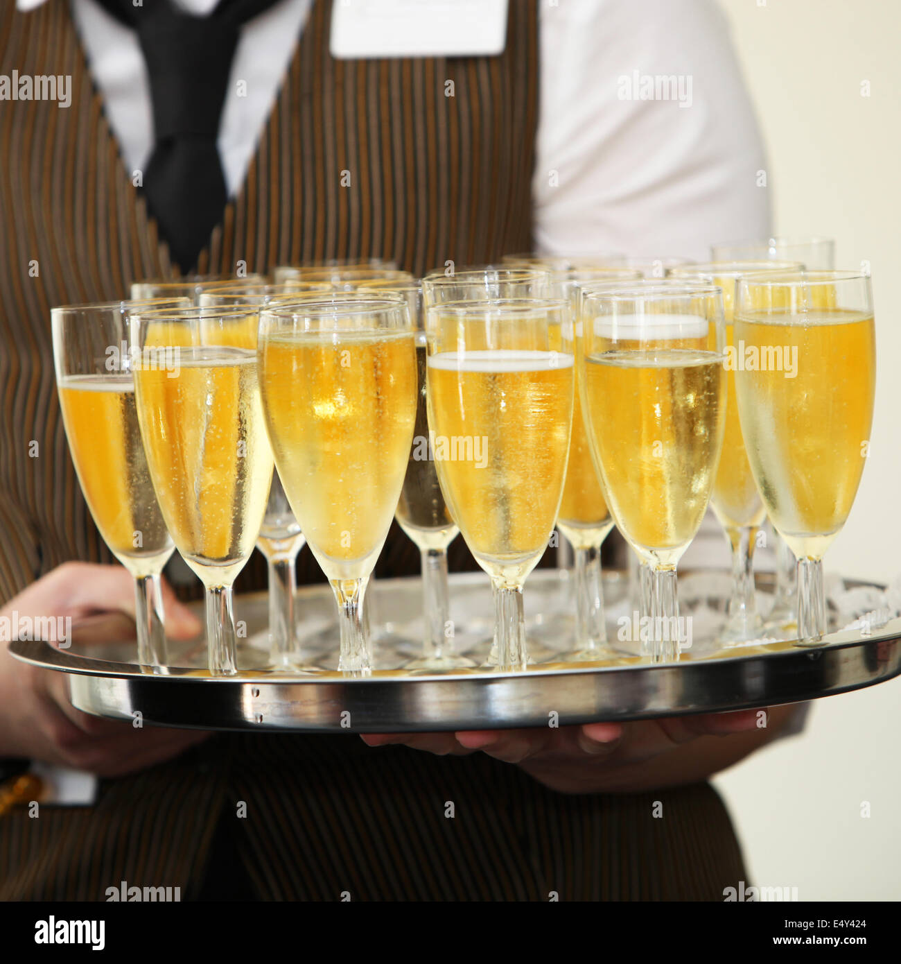 Waiter carrying a tray of champagne Stock Photo