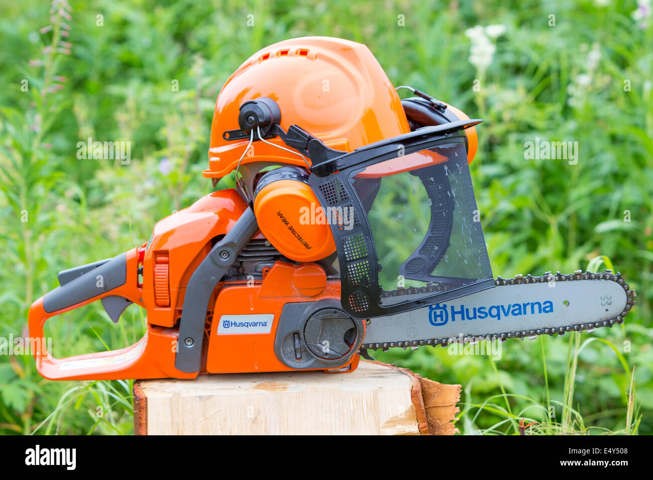 A chainsaw with a protection helmet Stock Photo Alamy