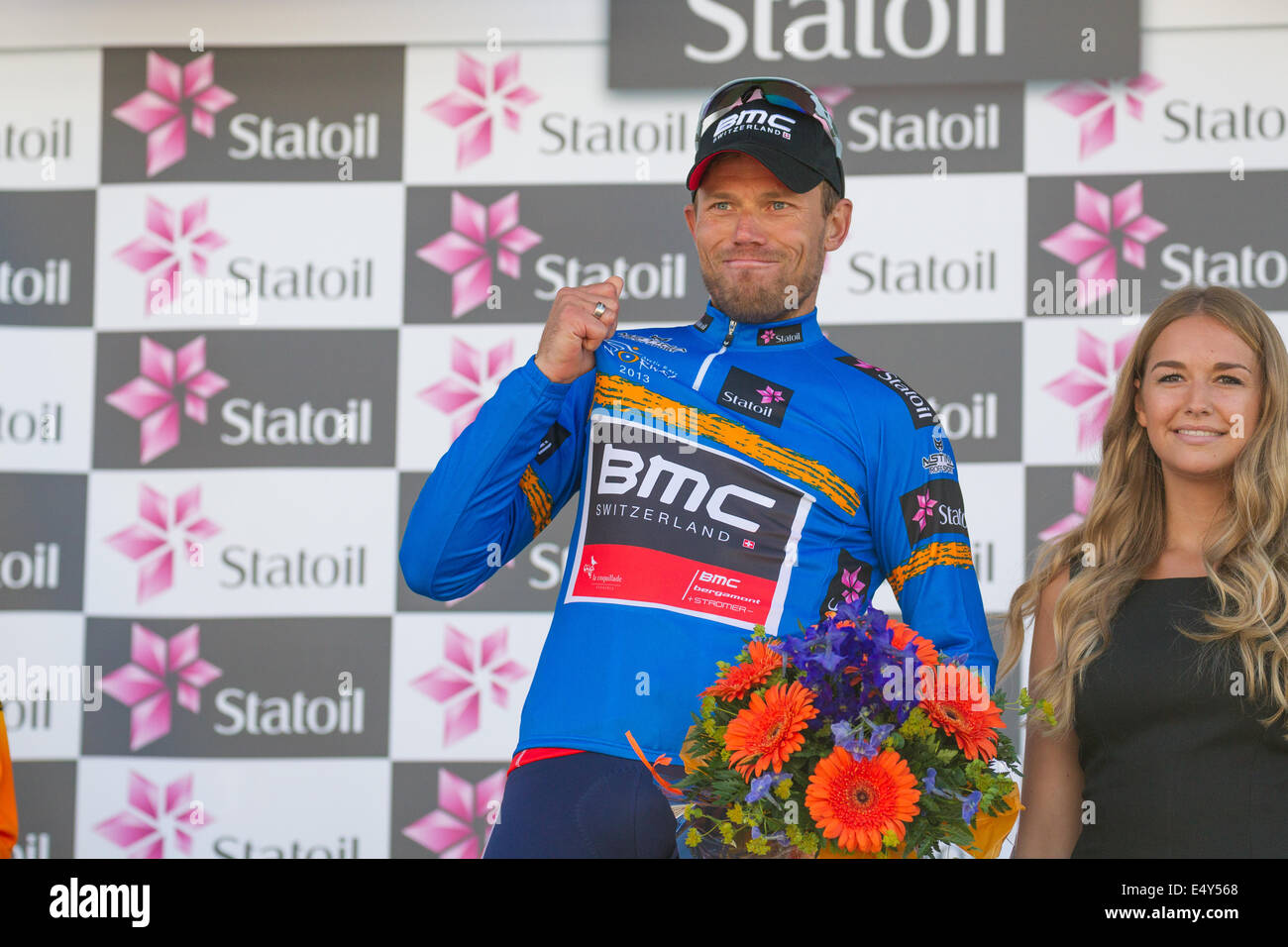 Thor Hushovd cheering after winning the 2013 Arctic Race of Norway. He is wearing the blue winner/leader jersey Stock Photo