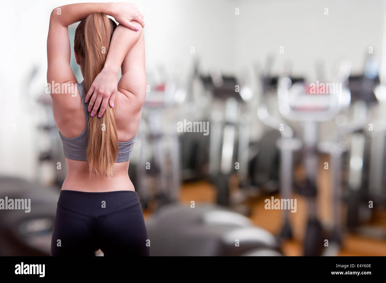 Sportive woman stretching arm hi-res stock photography and images - Alamy
