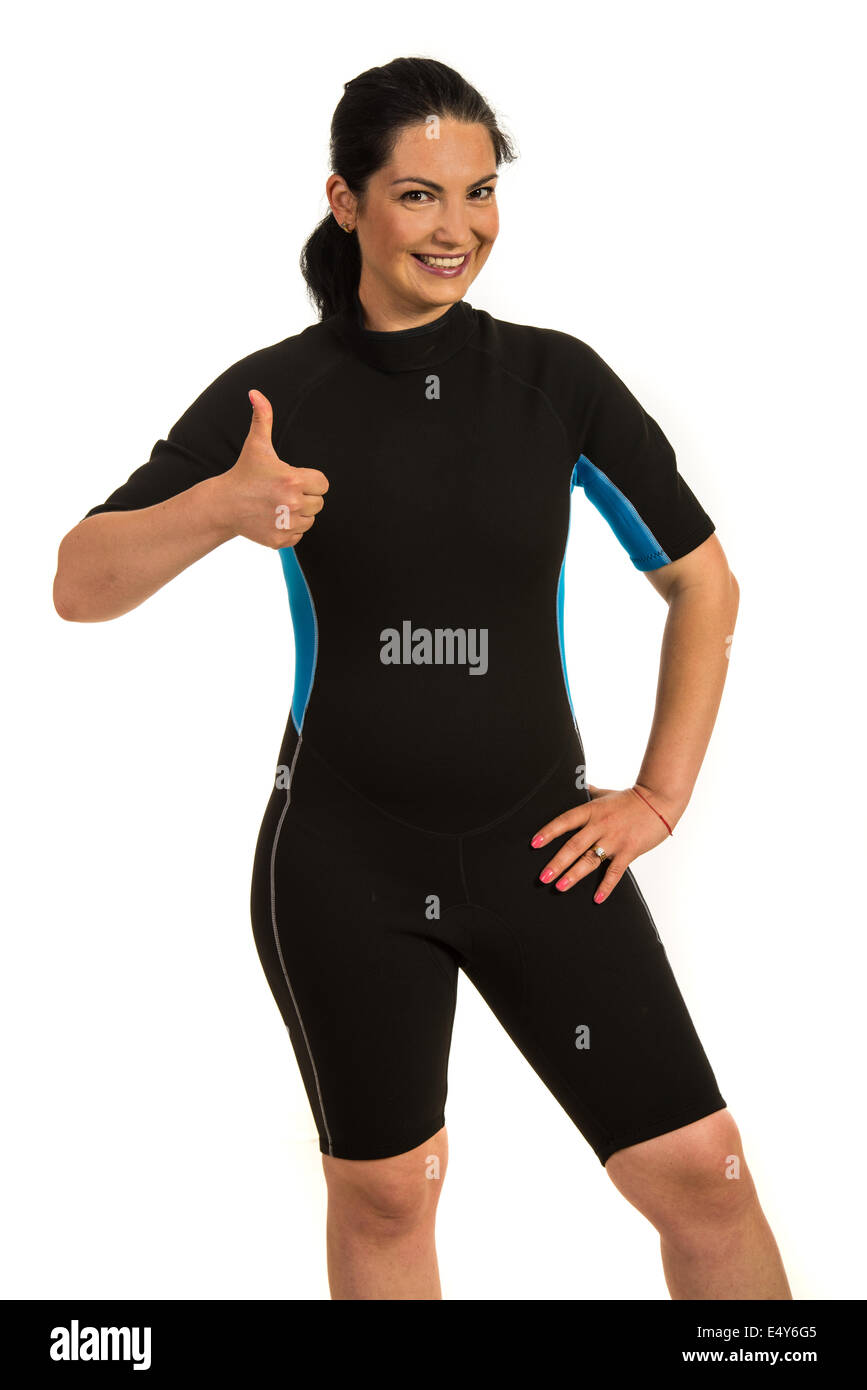 Successful surfer woman in neoprene suit giving thumbs up isolated on white background Stock Photo