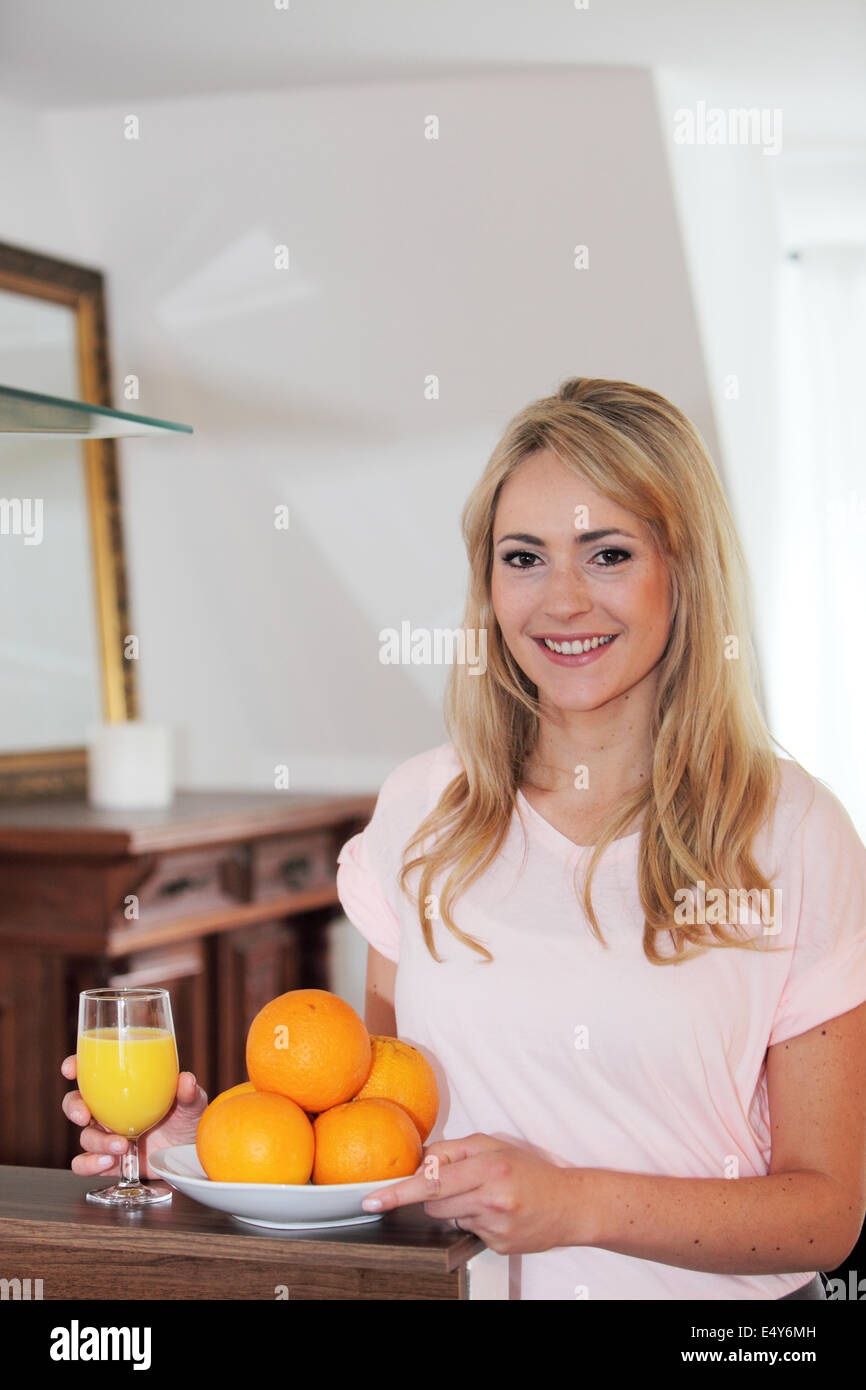 Smiling healthy woman with fresh oranges Stock Photo