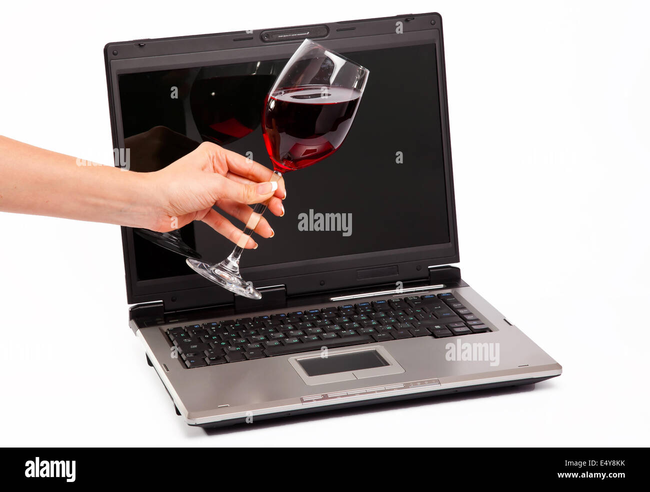 Laptop and glass of red wine Stock Photo