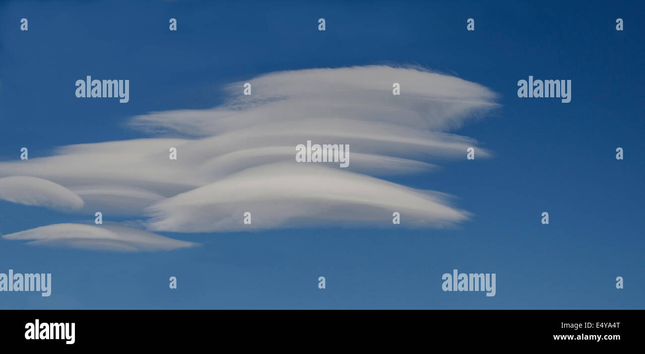 Lenticular (lens shaped) clouds are a frequent phenomenon in the sky above the Alaska Range of Mountains in Denali National Park Stock Photo