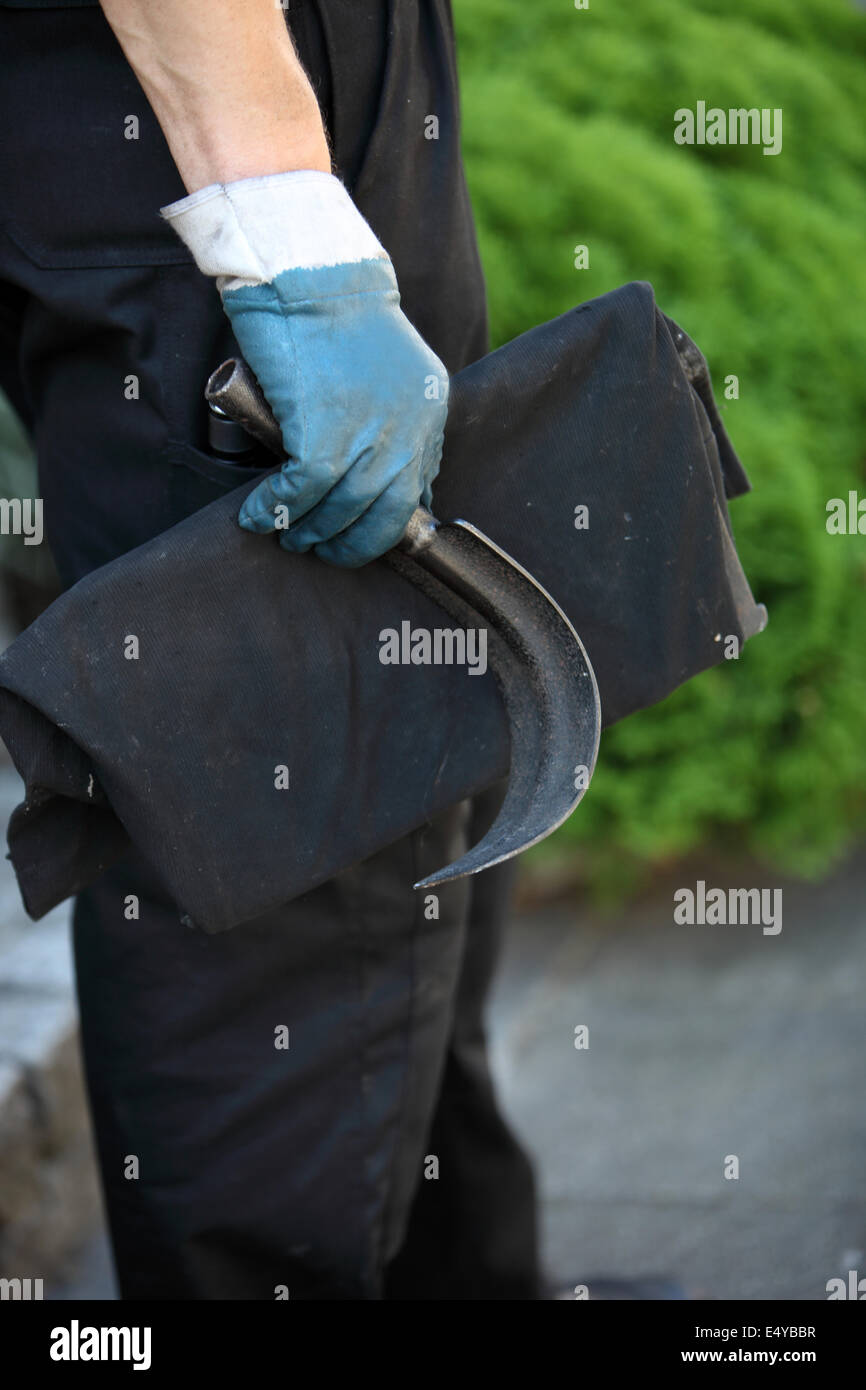 Chimney sweep holding a scraping tool Stock Photo