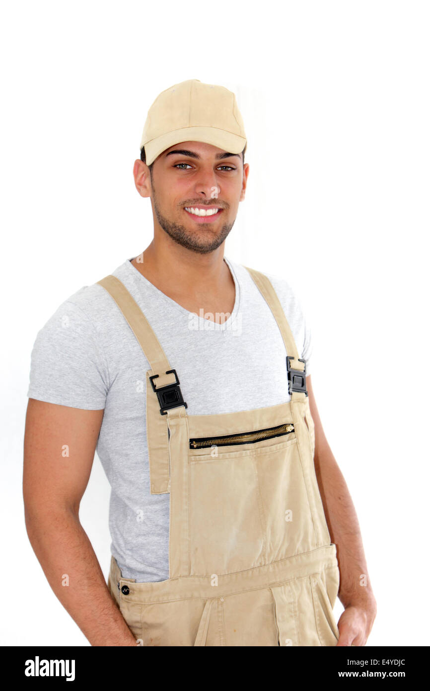 Handsome man in cap and dungarees Stock Photo