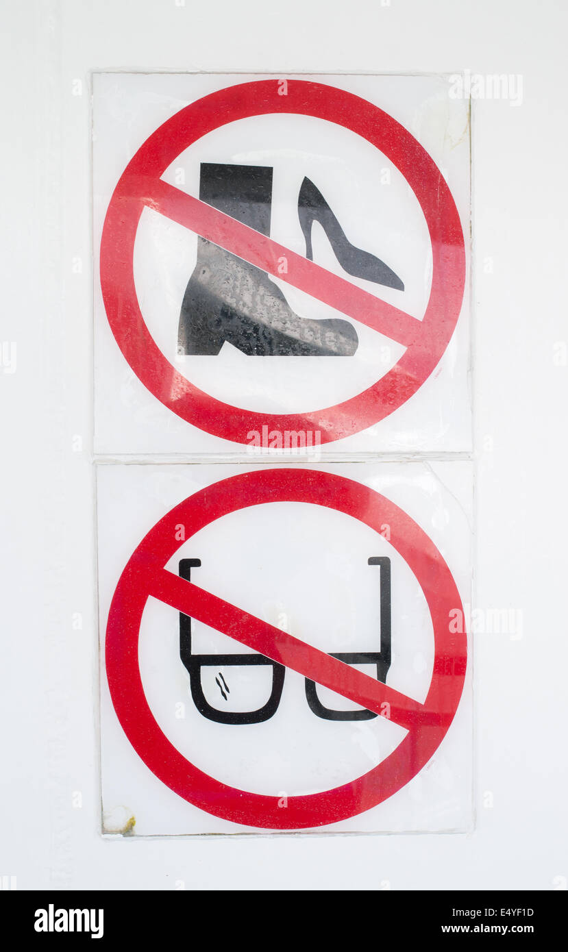 Unusual warning notice on board RORO ferry Pont Aven prohibiting the use of work boots, high heels, or glasses on escape chute. Stock Photo