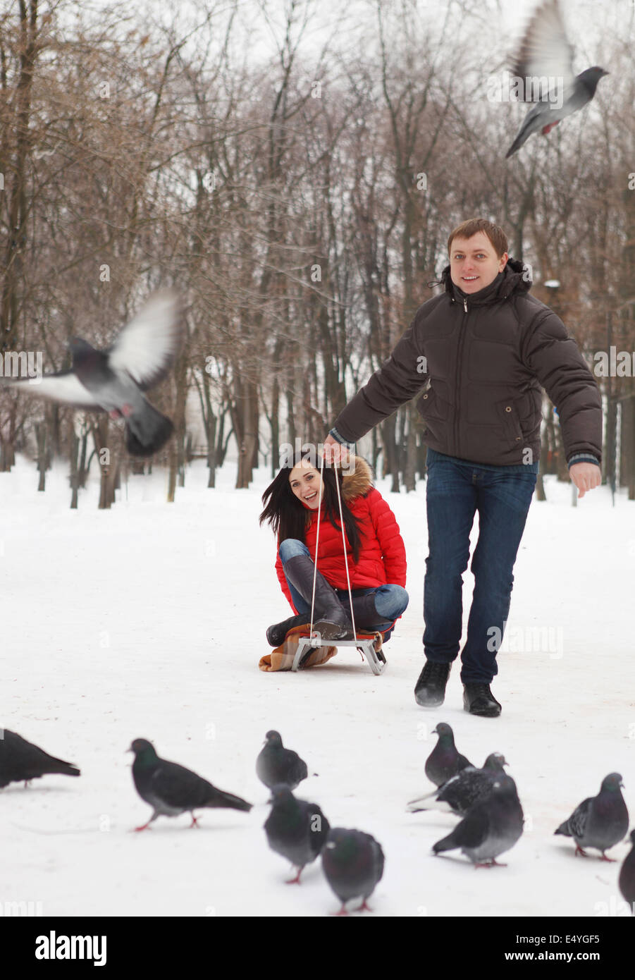 Young couple in winter park Stock Photo - Alamy
