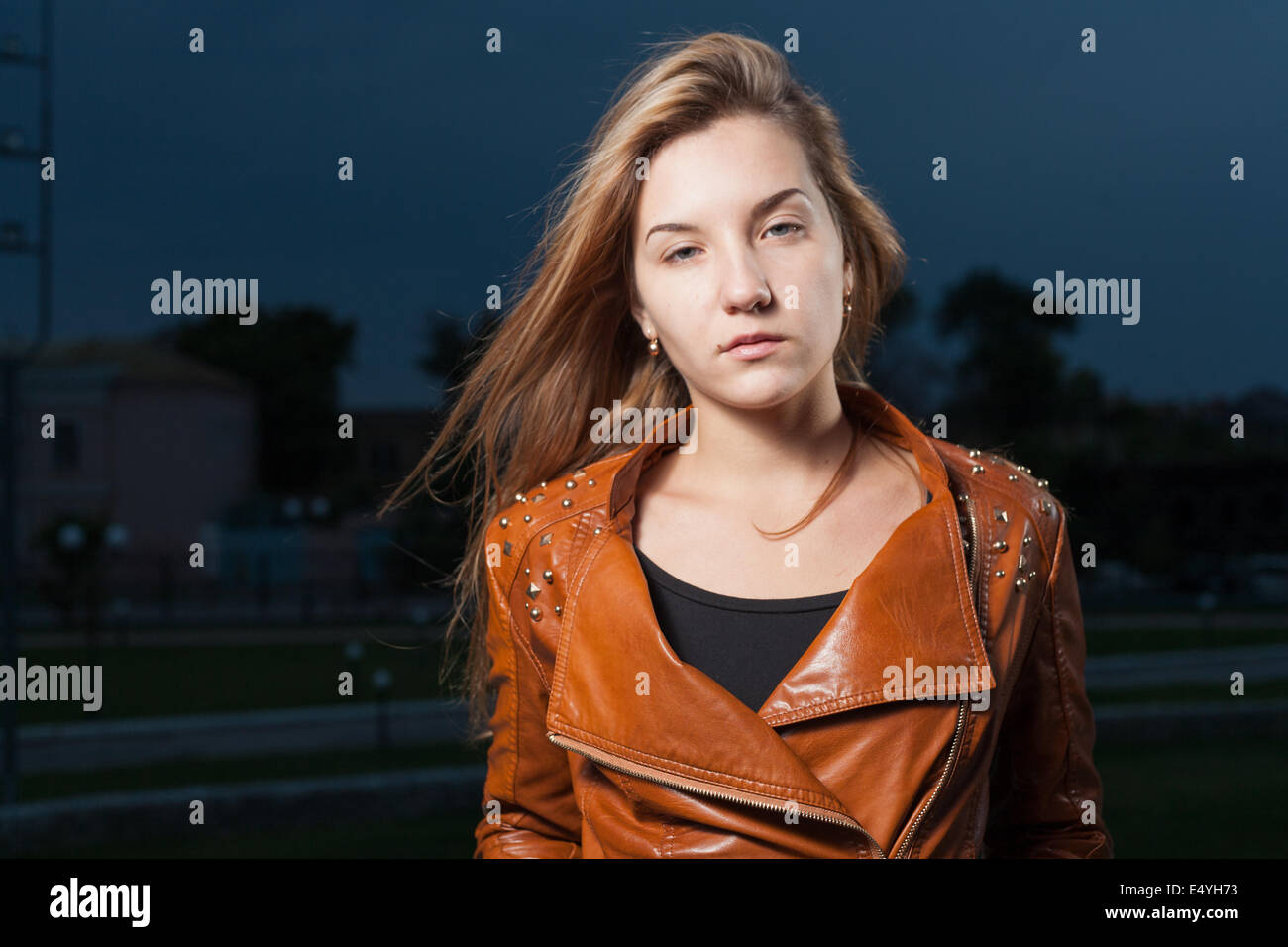 Sad young 20s woman at night Stock Photo