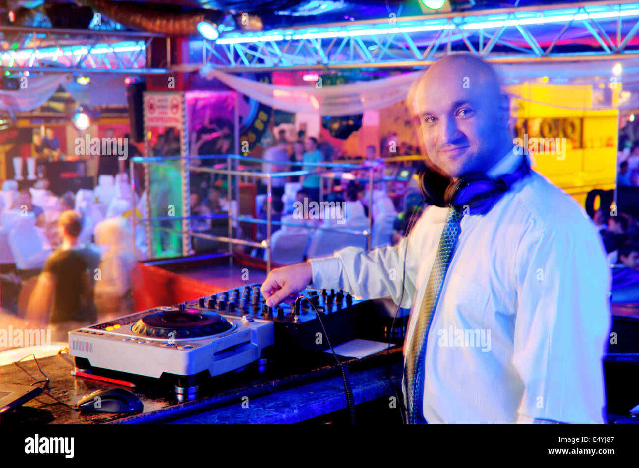 DJ behind the control panel Stock Photo - Alamy