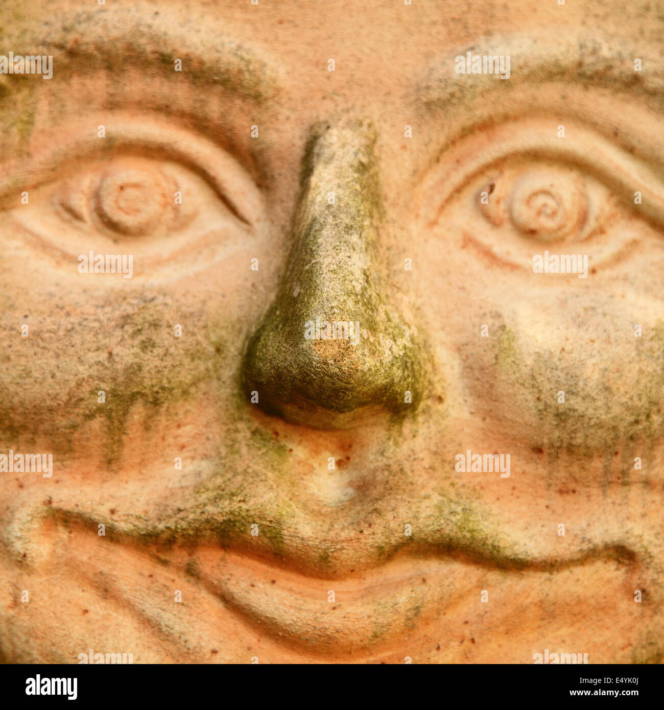 Smiling terracotta face Stock Photo