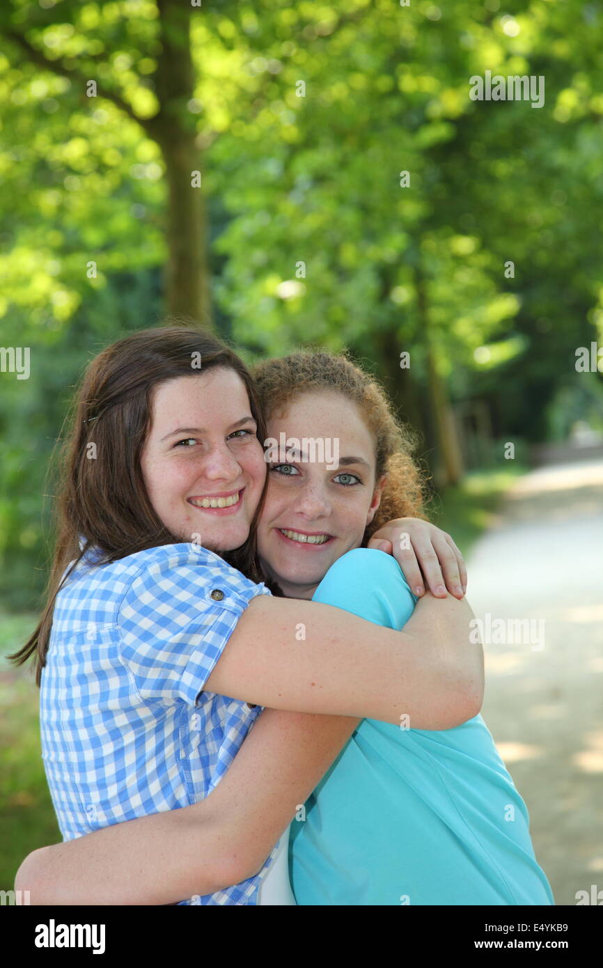 Two young teenage friends hugging Stock Photo