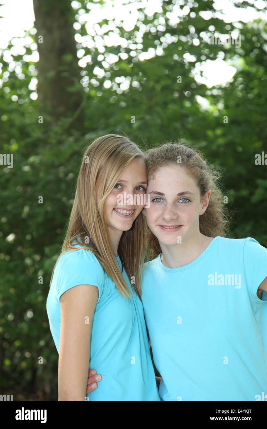 Pretty young girls in matching blue tops Stock Photo