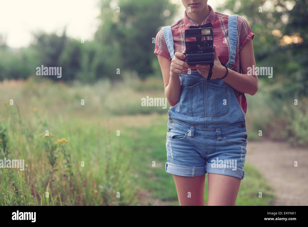 Hipster girl posing with instant camera Stock Photo