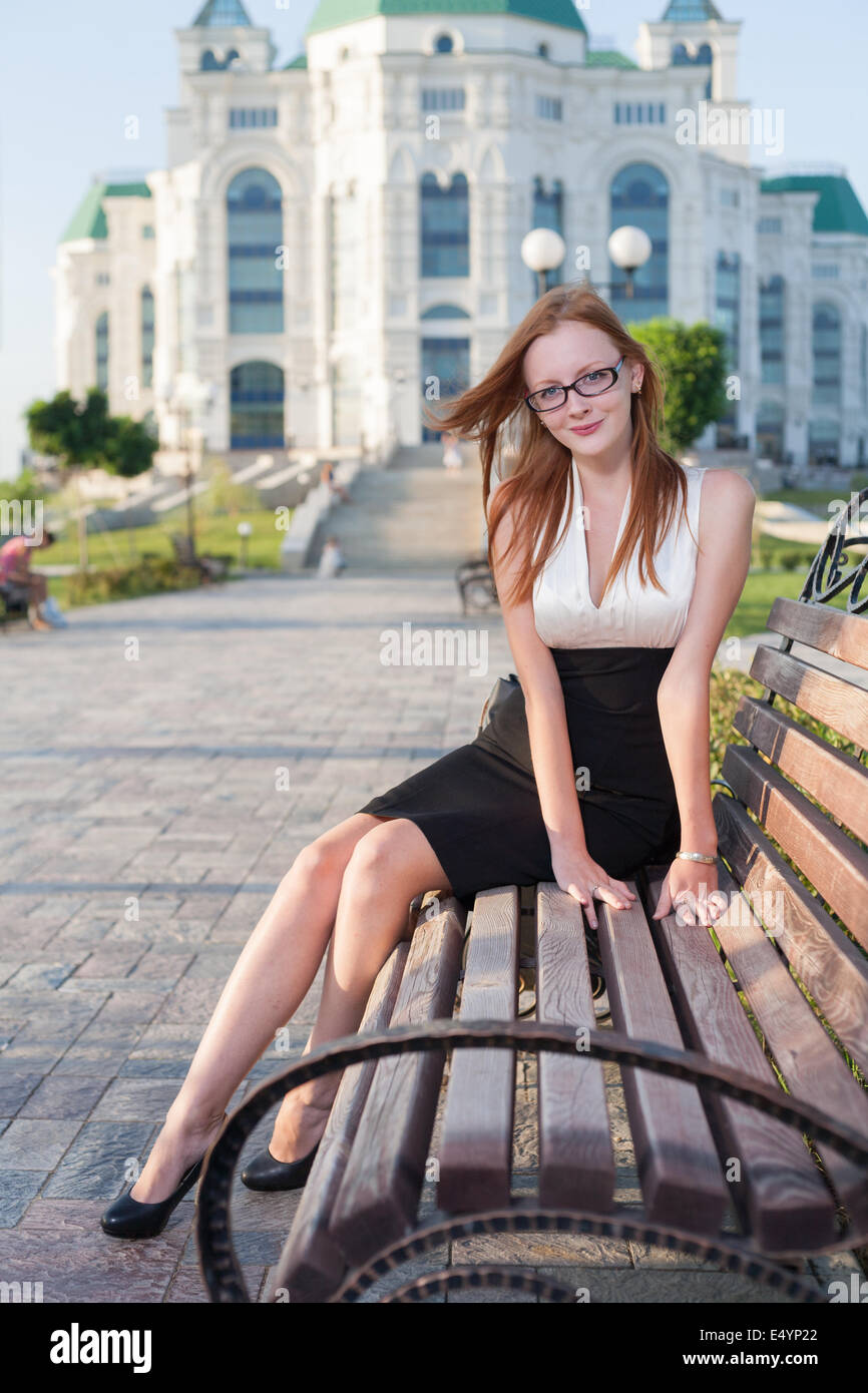 pretty teen girl sitting on the bench Stock Photo