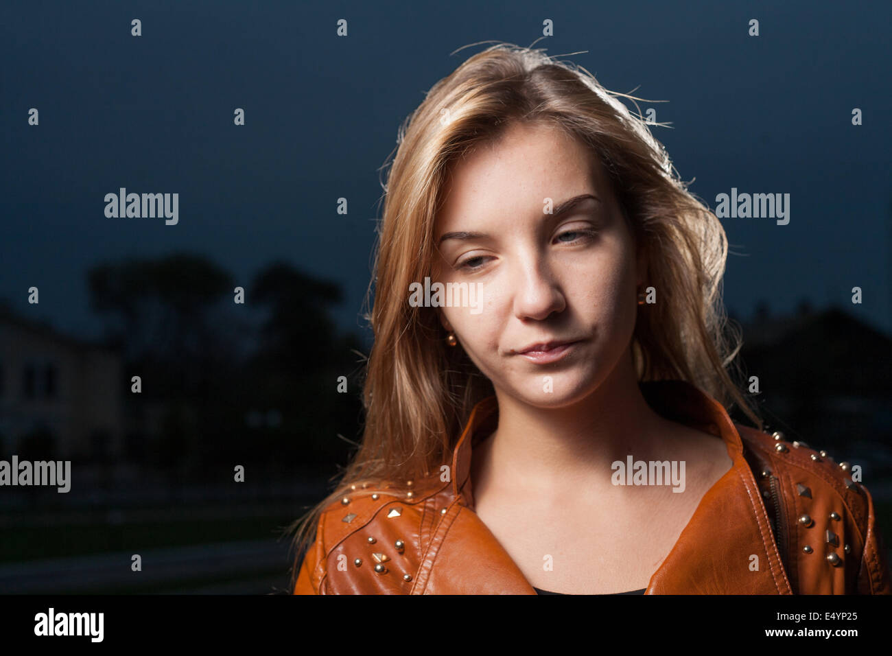 Sad young 20s woman at night Stock Photo