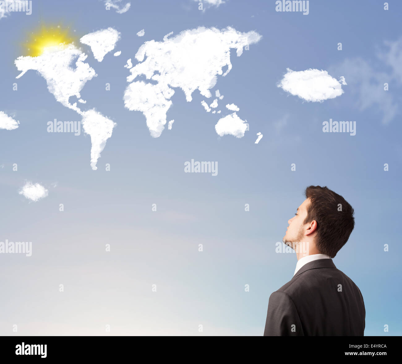 Businessman looking at world clouds and sun on blue sky Stock Photo - Alamy