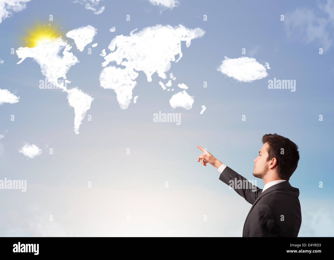 Businessman looking at world clouds and sun on blue sky Stock Photo - Alamy