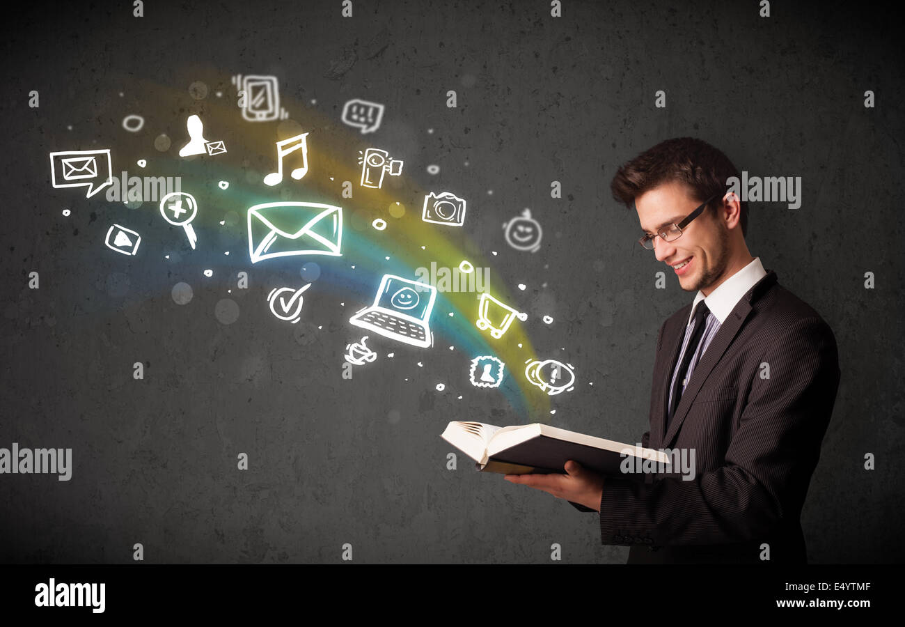 Young businessman reading a book with multimedia icons coming out of