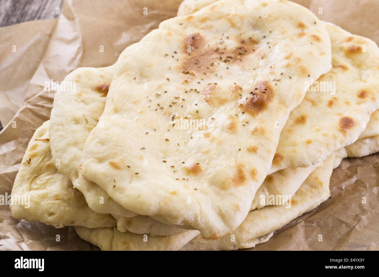 Woman using a dough cutter to divide the naan bread dough into six equal  portions which are flattened and baked. Bakers and pas Stock Photo - Alamy