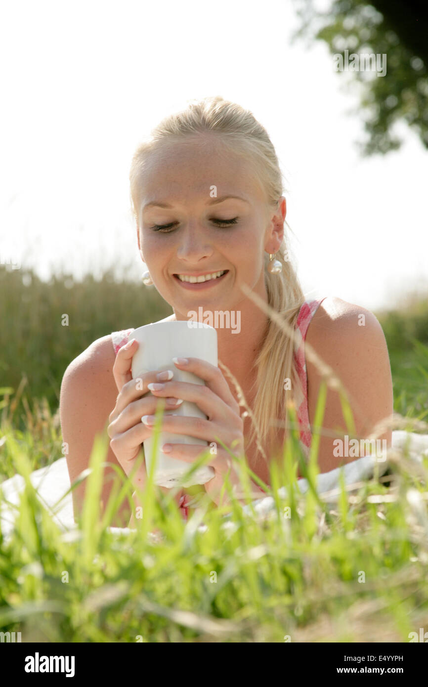 Young woman relaxing in the grass Stock Photo - Alamy