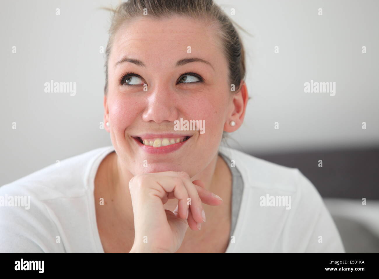 Beautiful smiling woman daydreaming Stock Photo