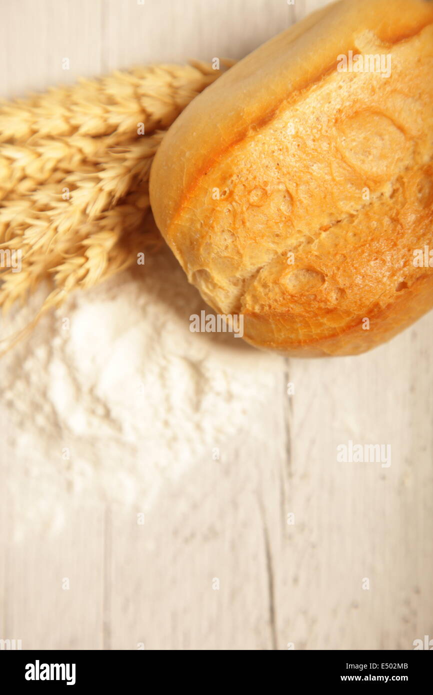 Crusty fresh roll with wheat and flour Stock Photo