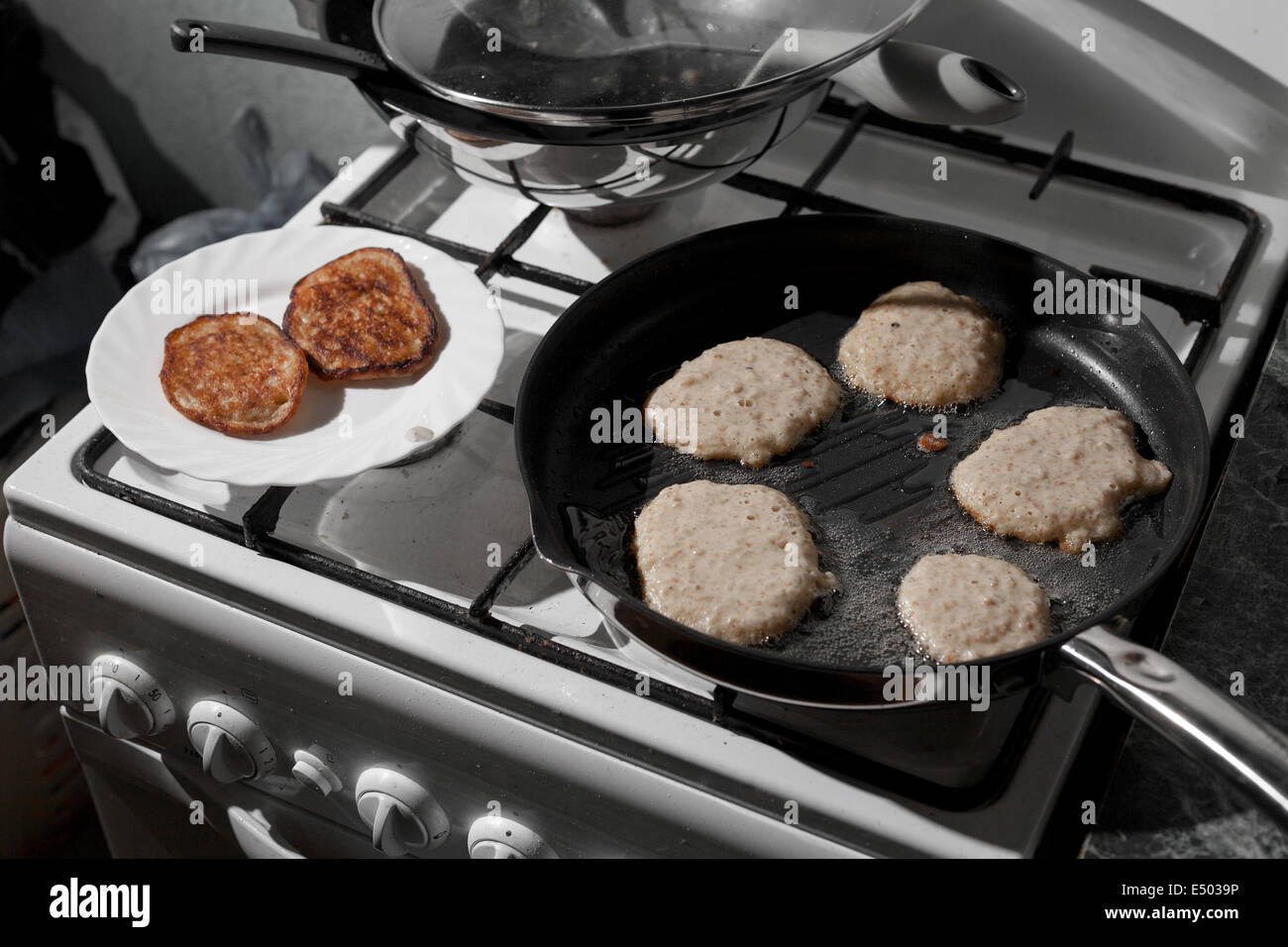 Pans on the stove in a kitchen Stock Photo Alamy