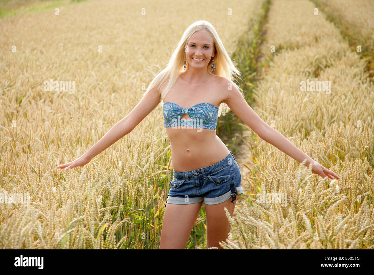 young slender woman in corn field Stock Photo