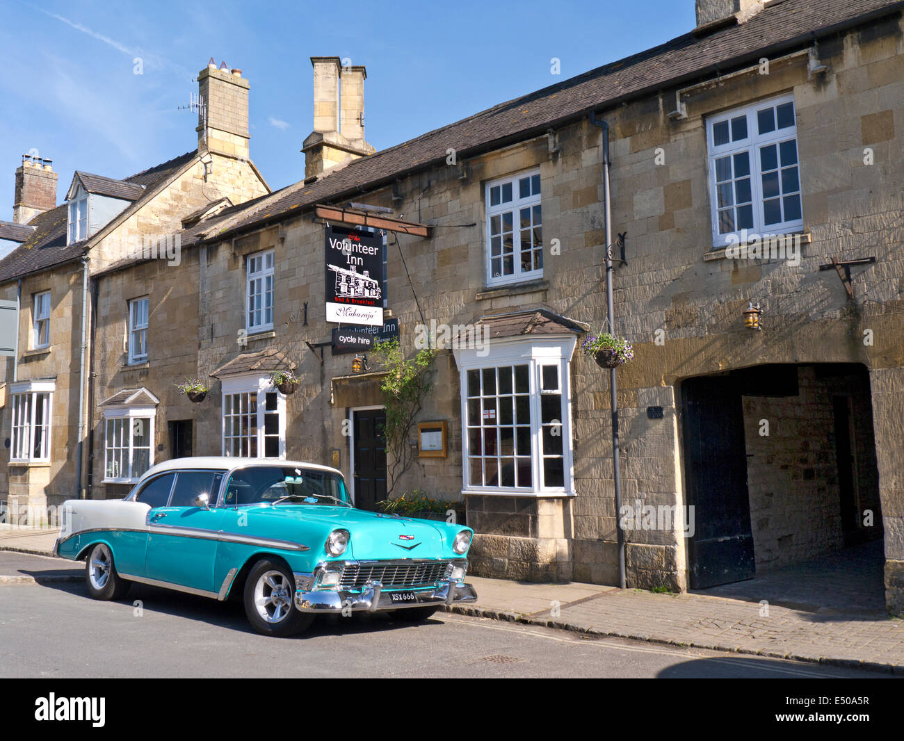 1950's/60's Chevrolet Bel Air Hardtop American classic car outside a historic old stone Cotswolds B&B public house Stock Photo